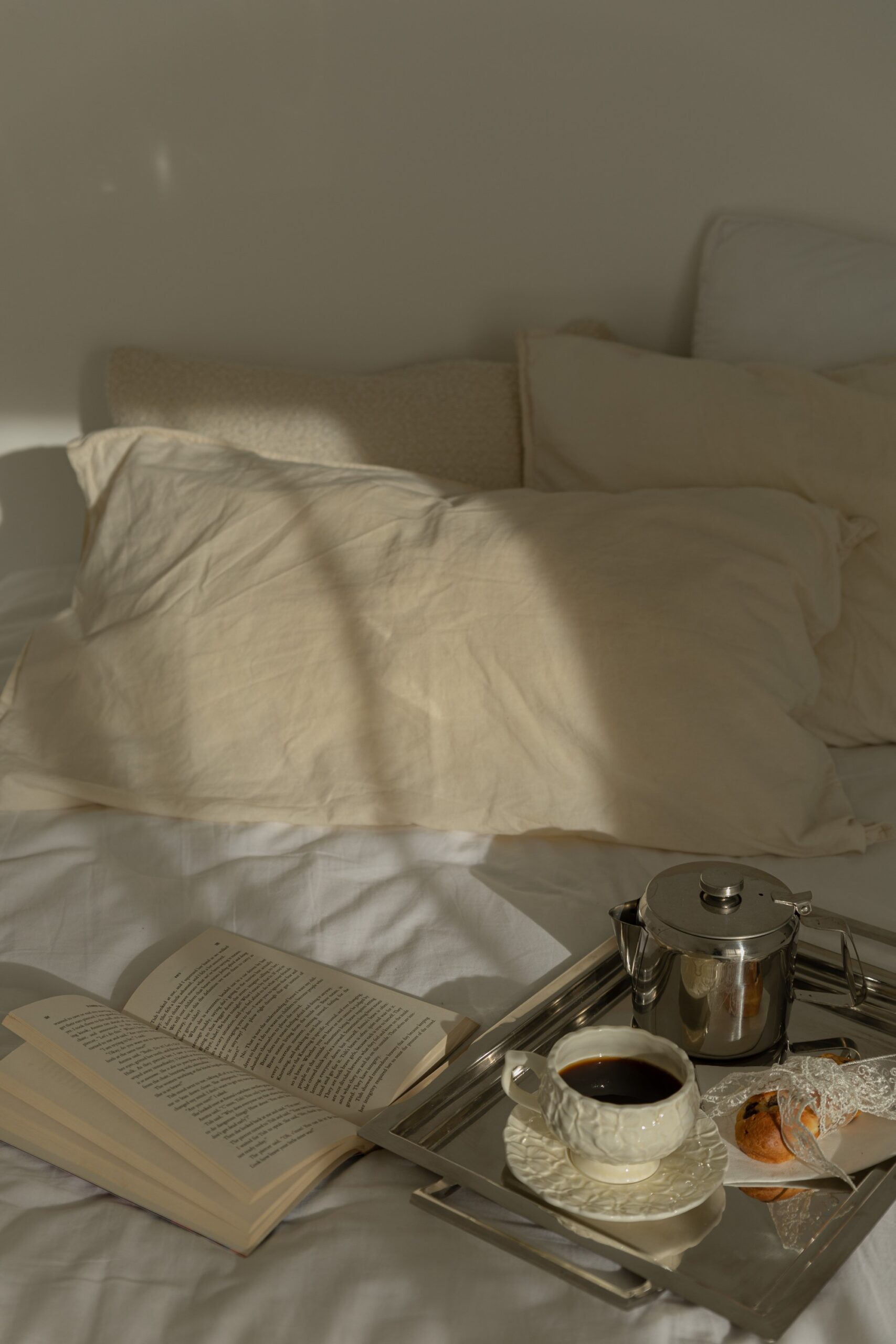 Crisp white bed linen and pillows in soft morning light