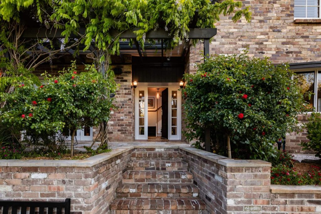 Cotswold Cottage front entry framed by climbing greenery
